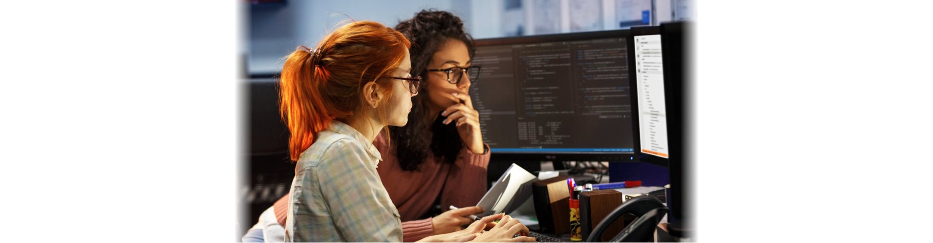 two woman discussing about their codes